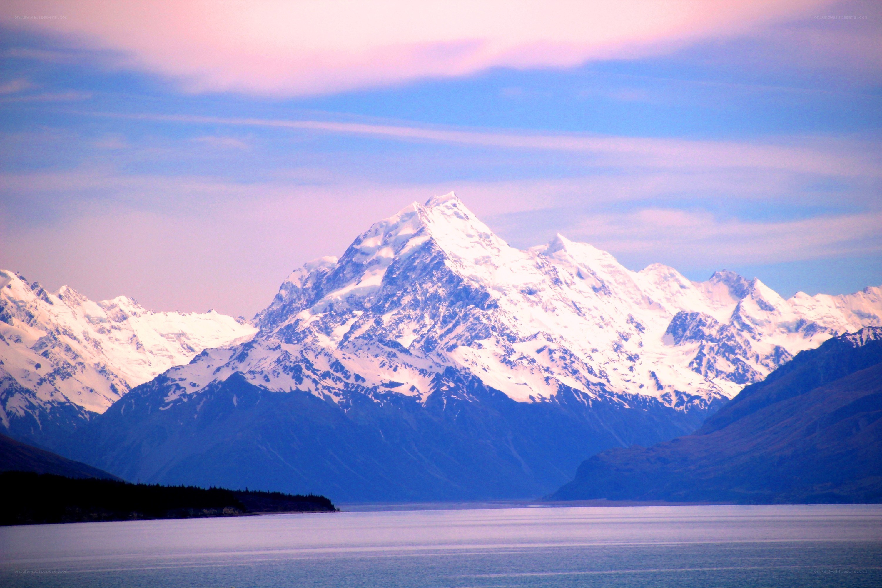 Snow-capped mountain by a lake