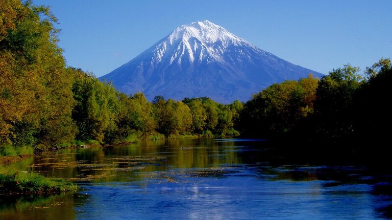 Snow-capped mountain by a river