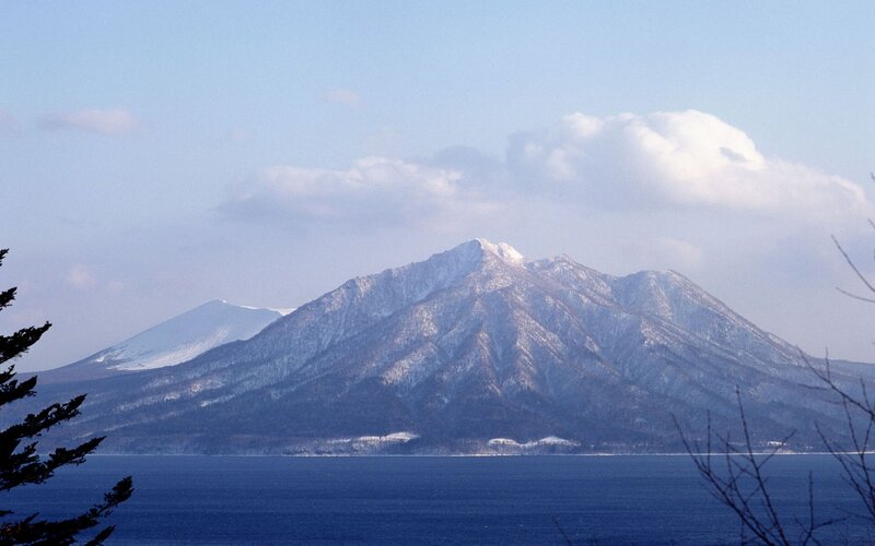 Snow-capped mountain by the sea