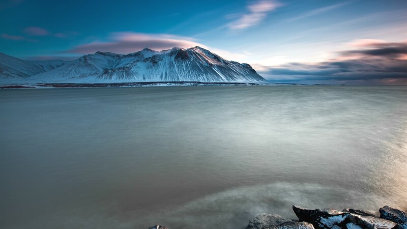 Snow-capped mountain by the sea