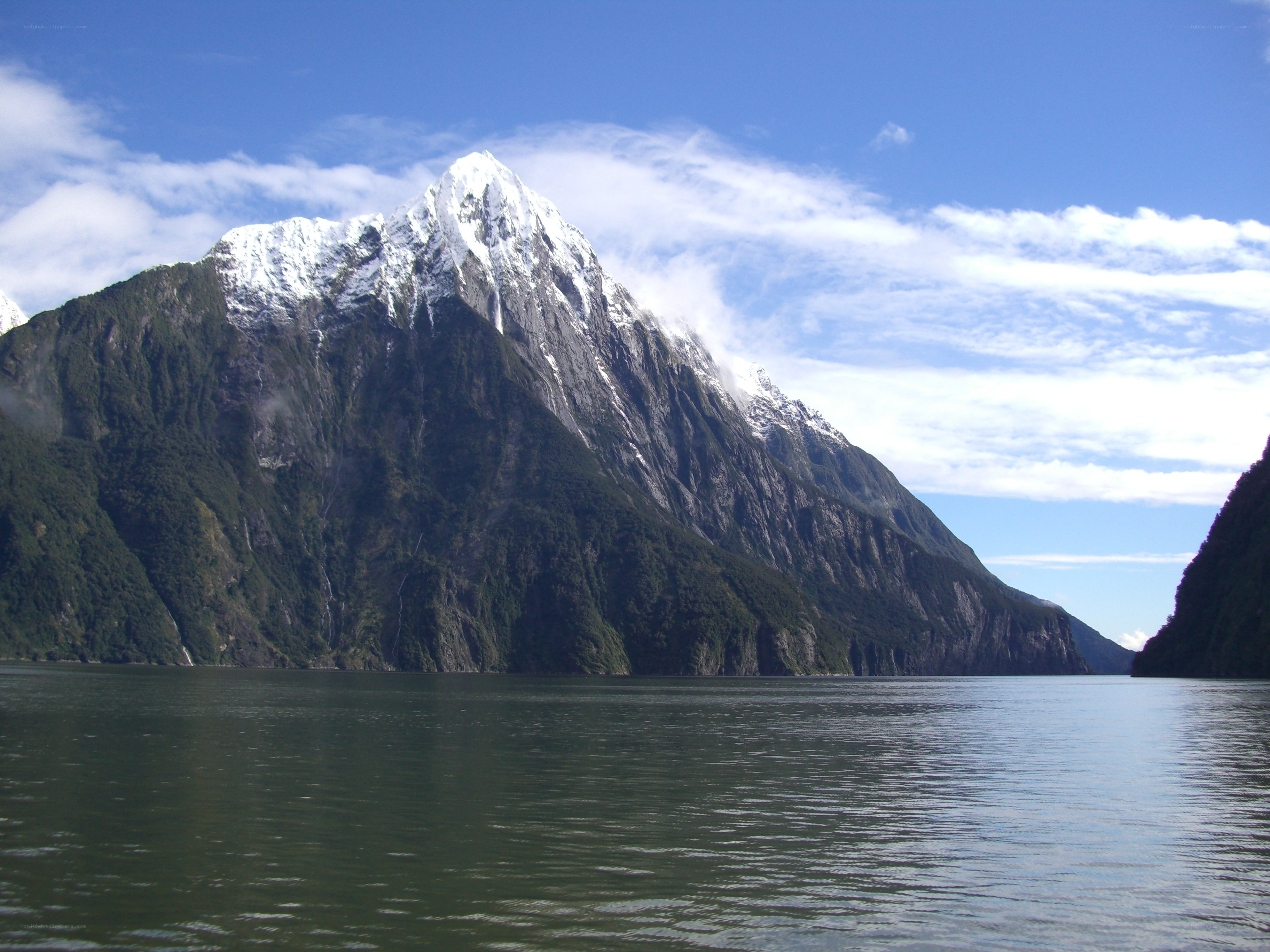 snow-capped mountain by the water