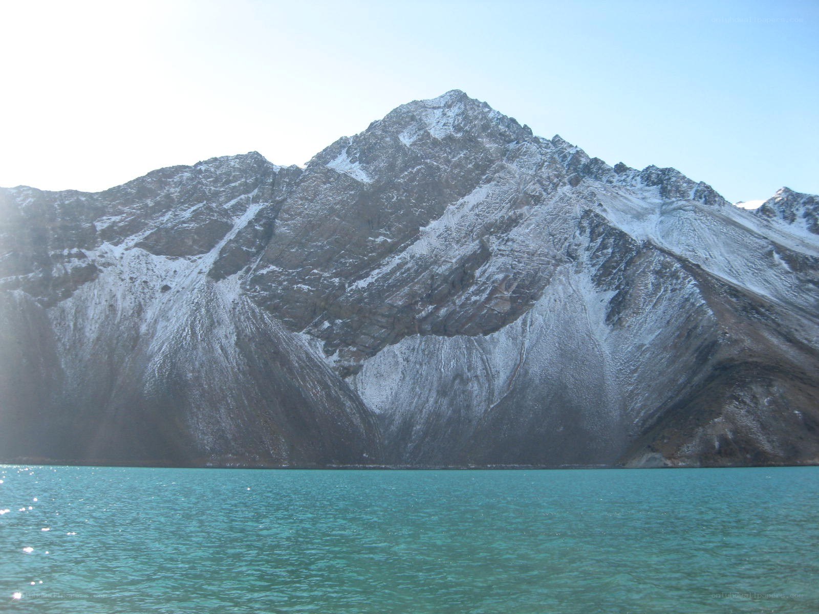 snow-capped mountain by turquoise lake
