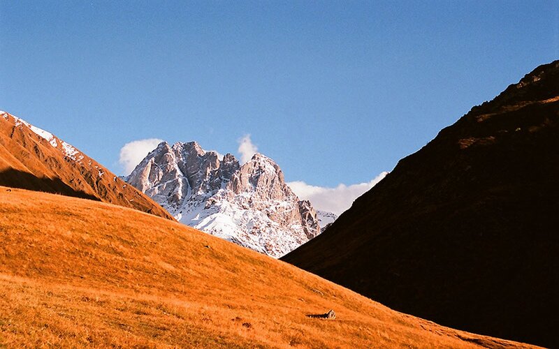 Snow-capped mountain in golden valley