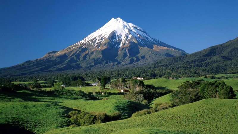 Snow-capped mountain in green valley