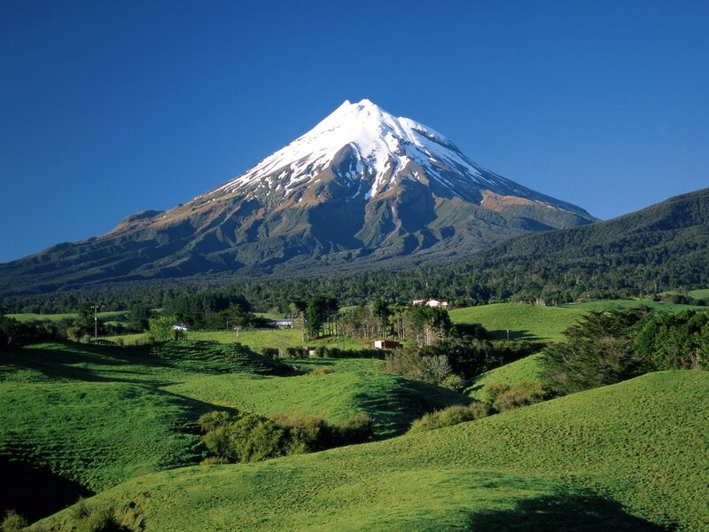Snow-capped mountain in green valley