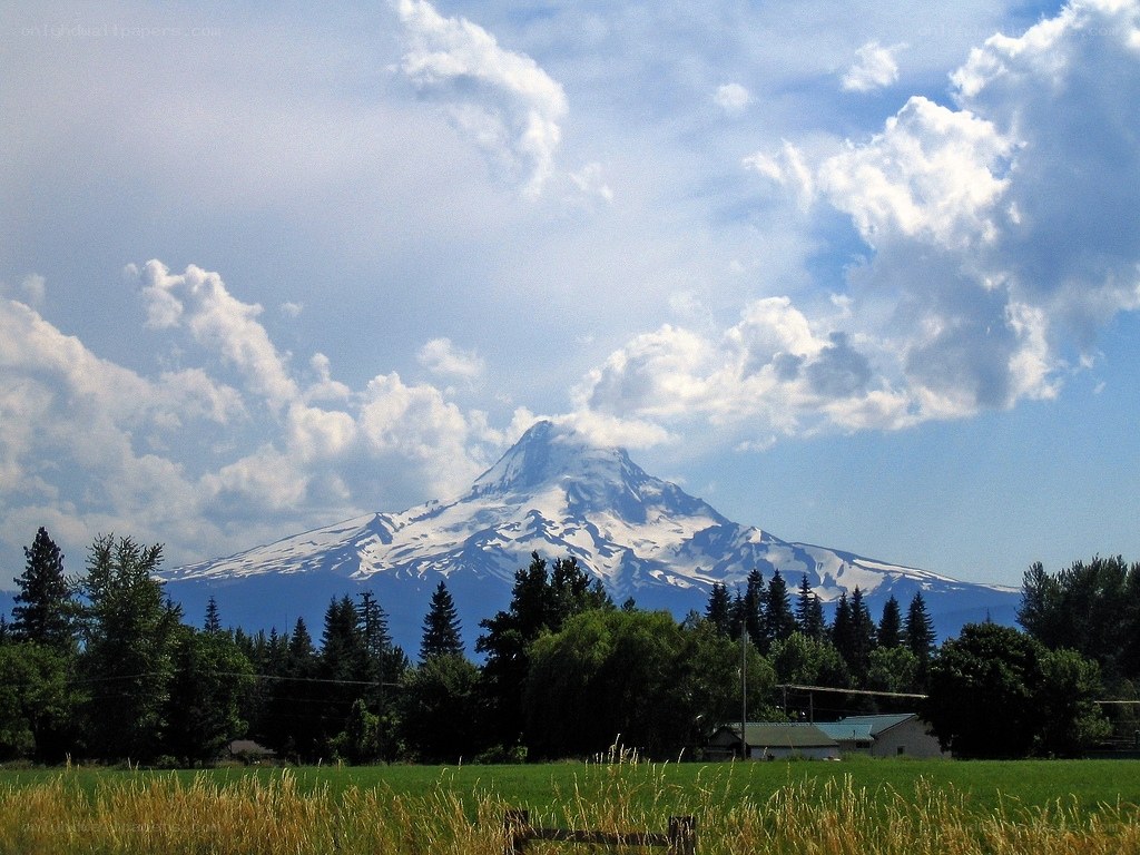 Snow-capped mountain in rural landscape