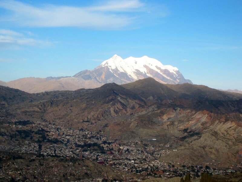 Snow-capped mountain overlooking a city