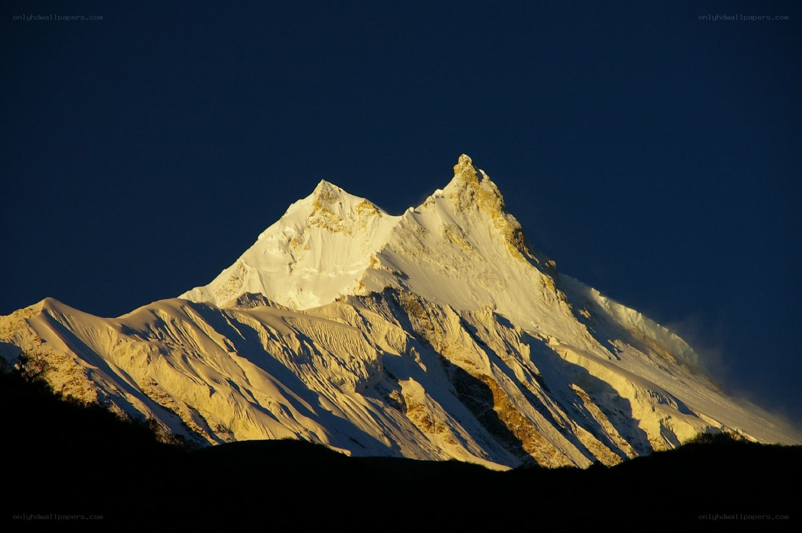 Snow-capped mountain peak at sunrise