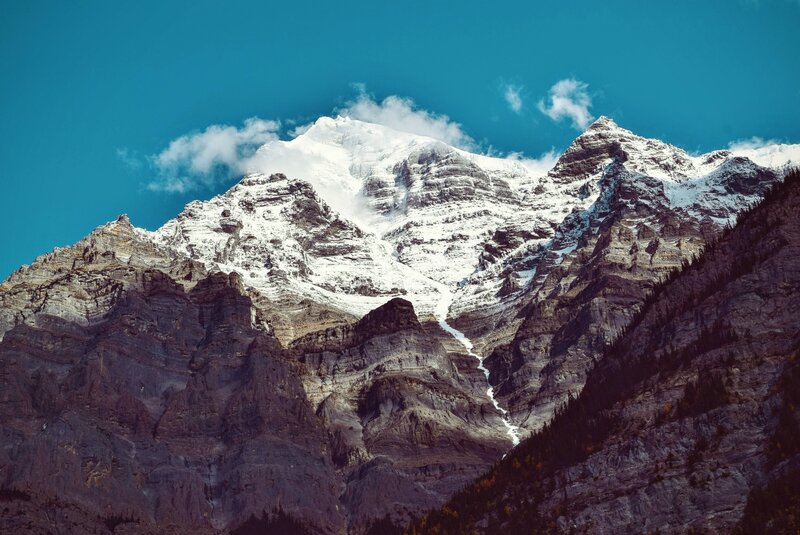 Snow-capped Mountain Peak — Blue, Dramatic, Afternoon, Photograph, Clouds, Rock, Trees