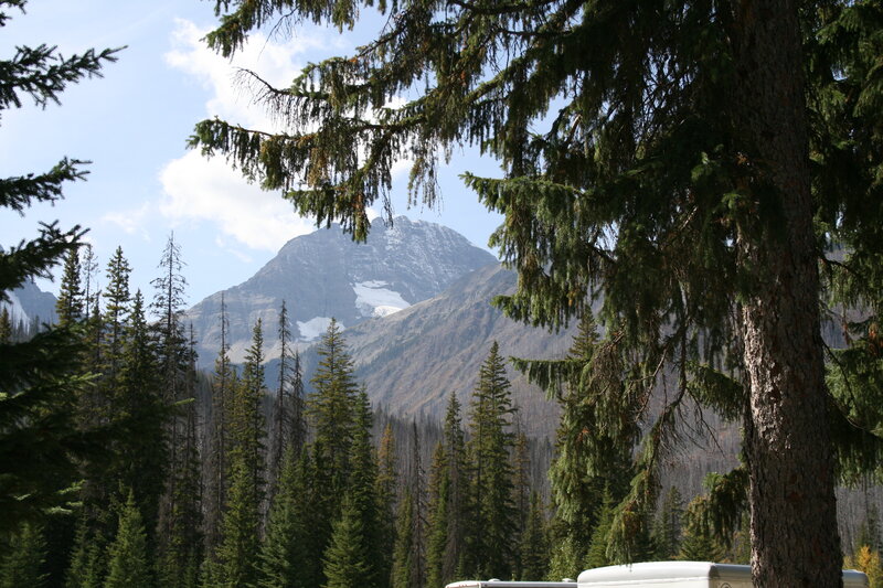 Snow-capped Mountain Peak — Green, Serene, Afternoon, Photograph, Evergreen Trees, Sky