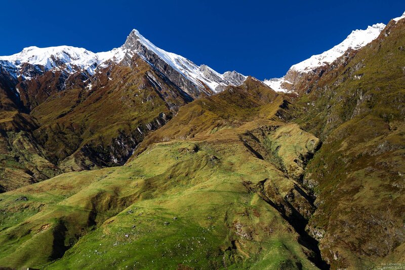Snow-capped Mountain Peak — Green, Serene, Afternoon, Photograph, Grass