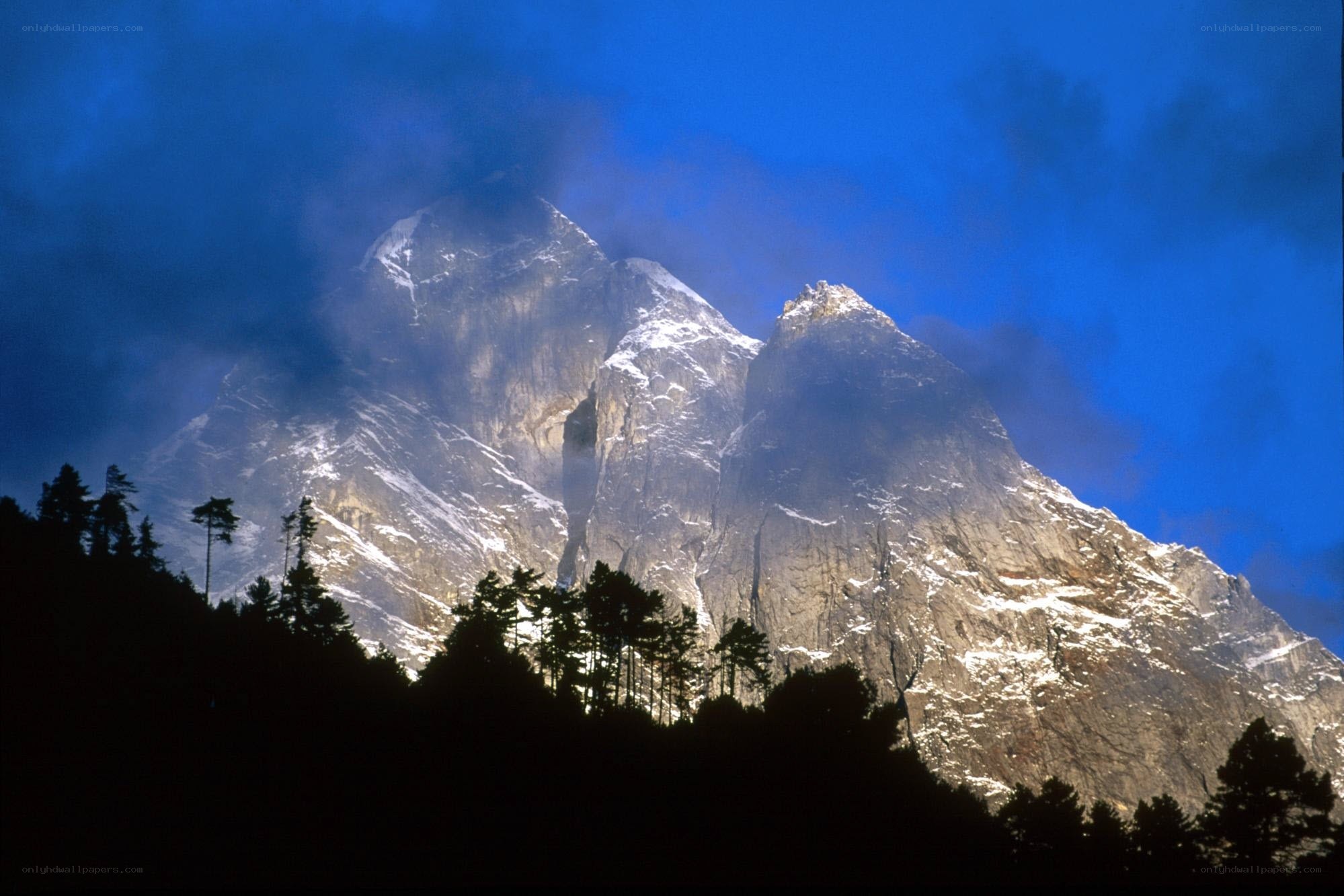 Snow-capped mountain peaks at dusk
