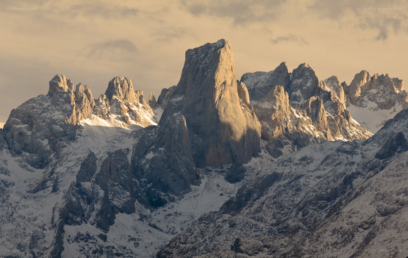 Snow-capped mountain peaks at sunrise