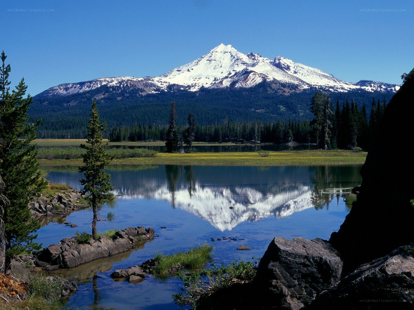 Snow-capped mountain reflected in lake
