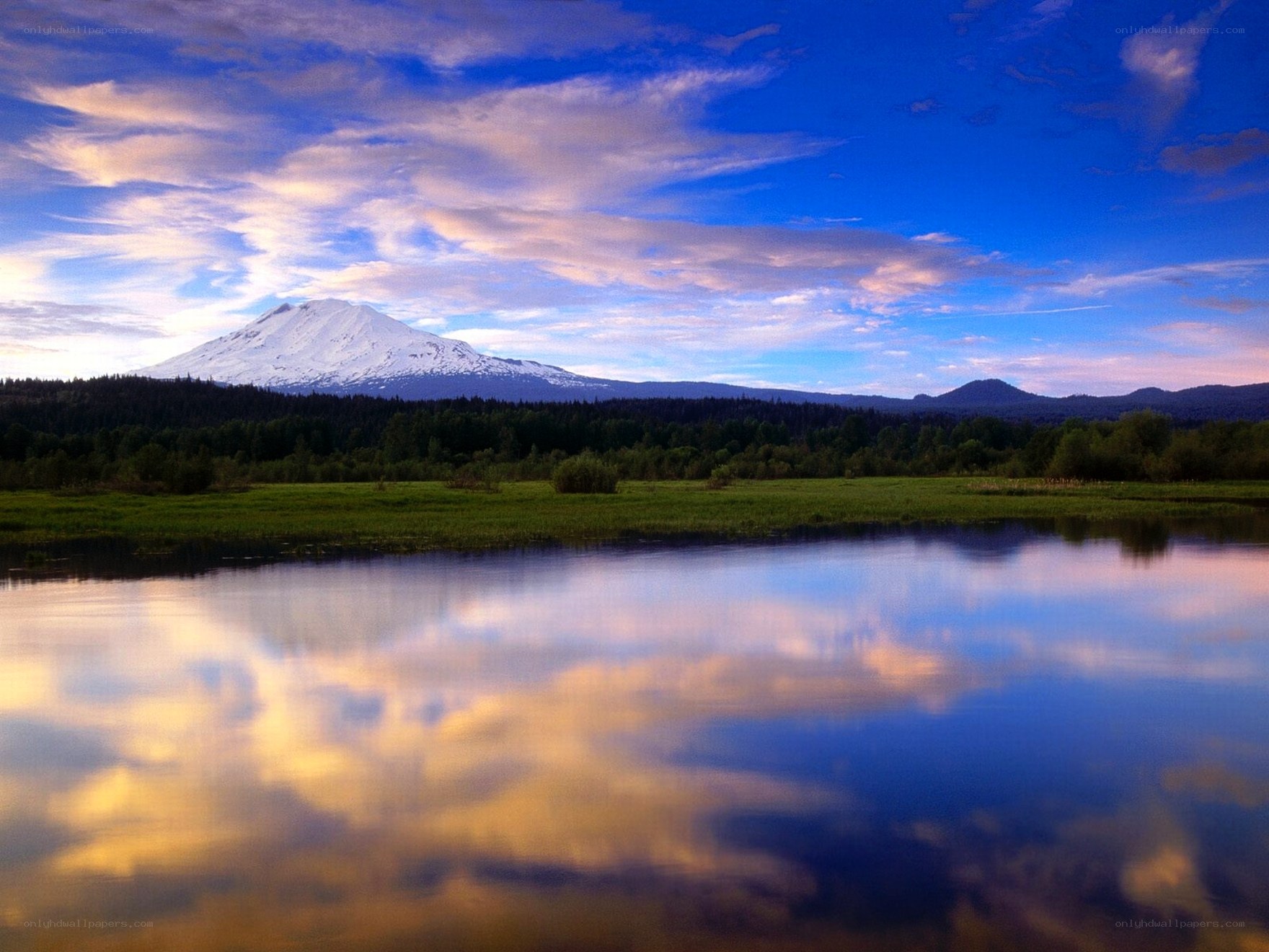 Snow-capped mountain reflected in lake