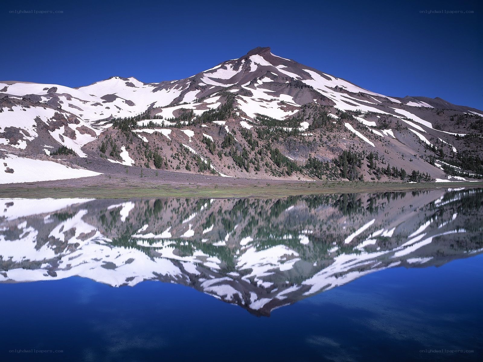 Snow-capped mountain reflected in lake