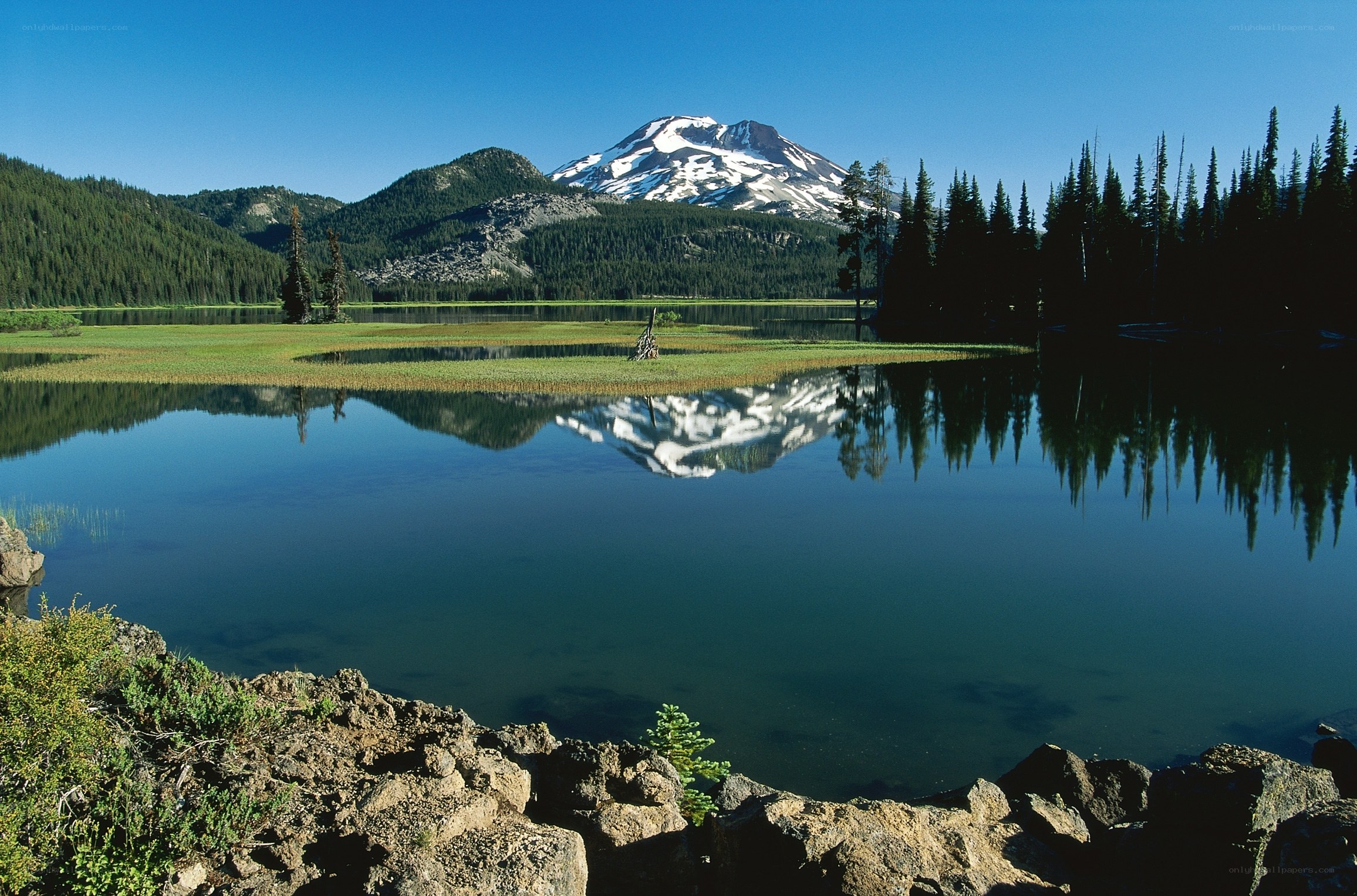 Snow-capped mountain reflected in lake