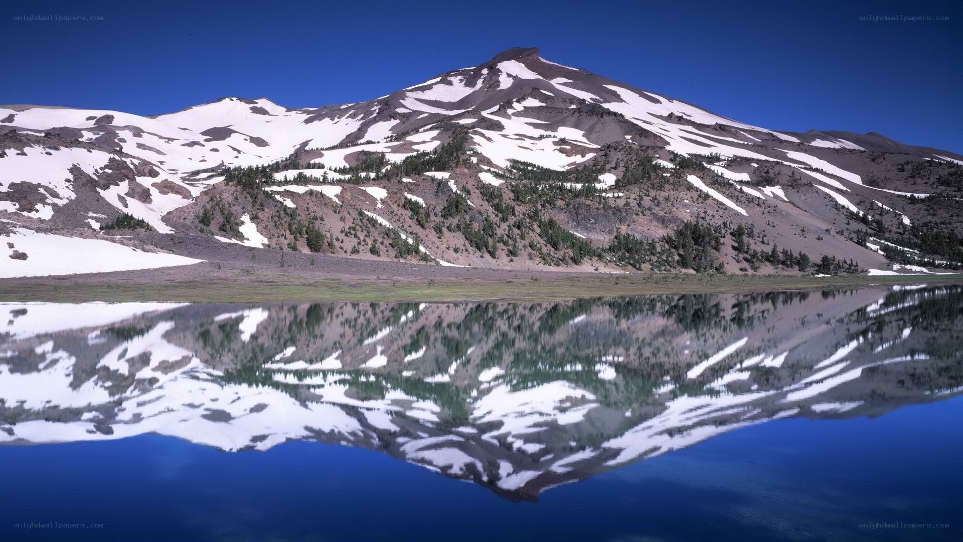 Snow-capped mountain reflected in lake