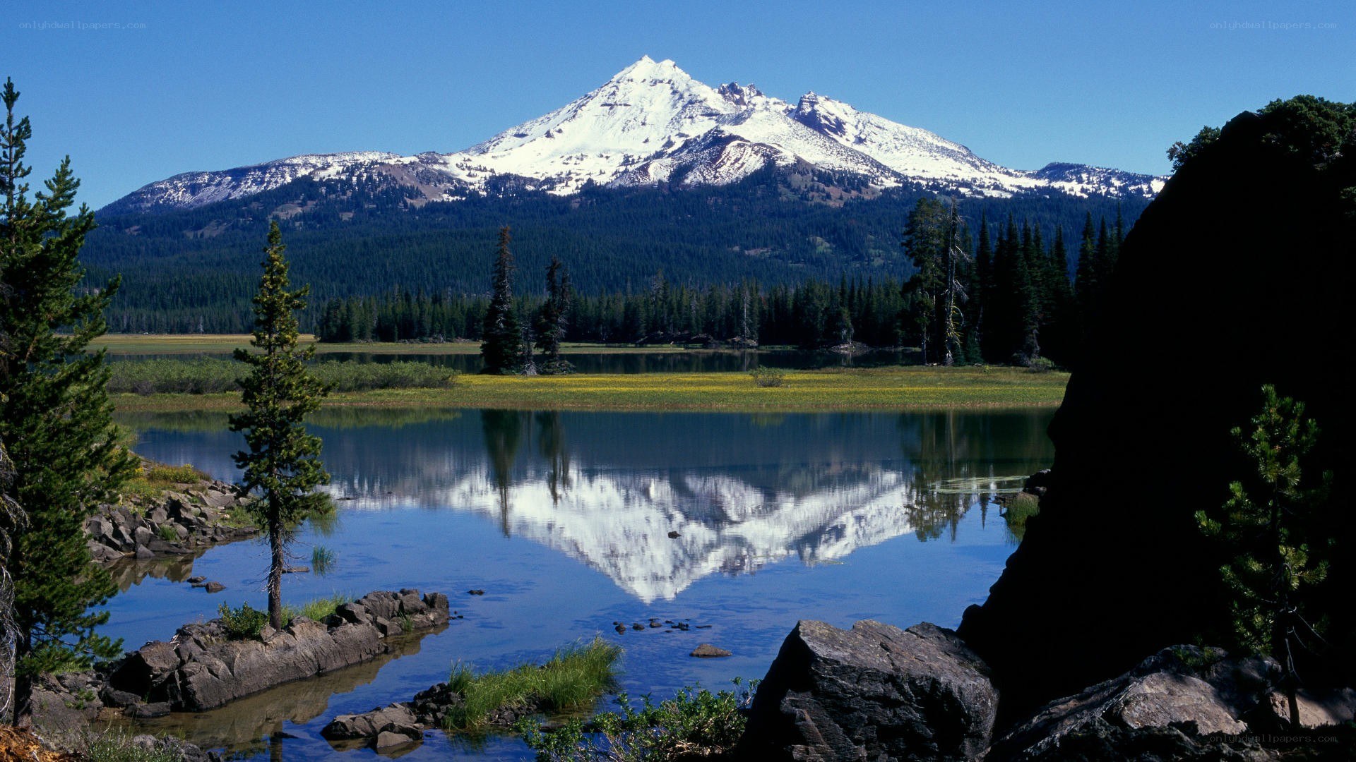 Snow-capped mountain reflected in lake