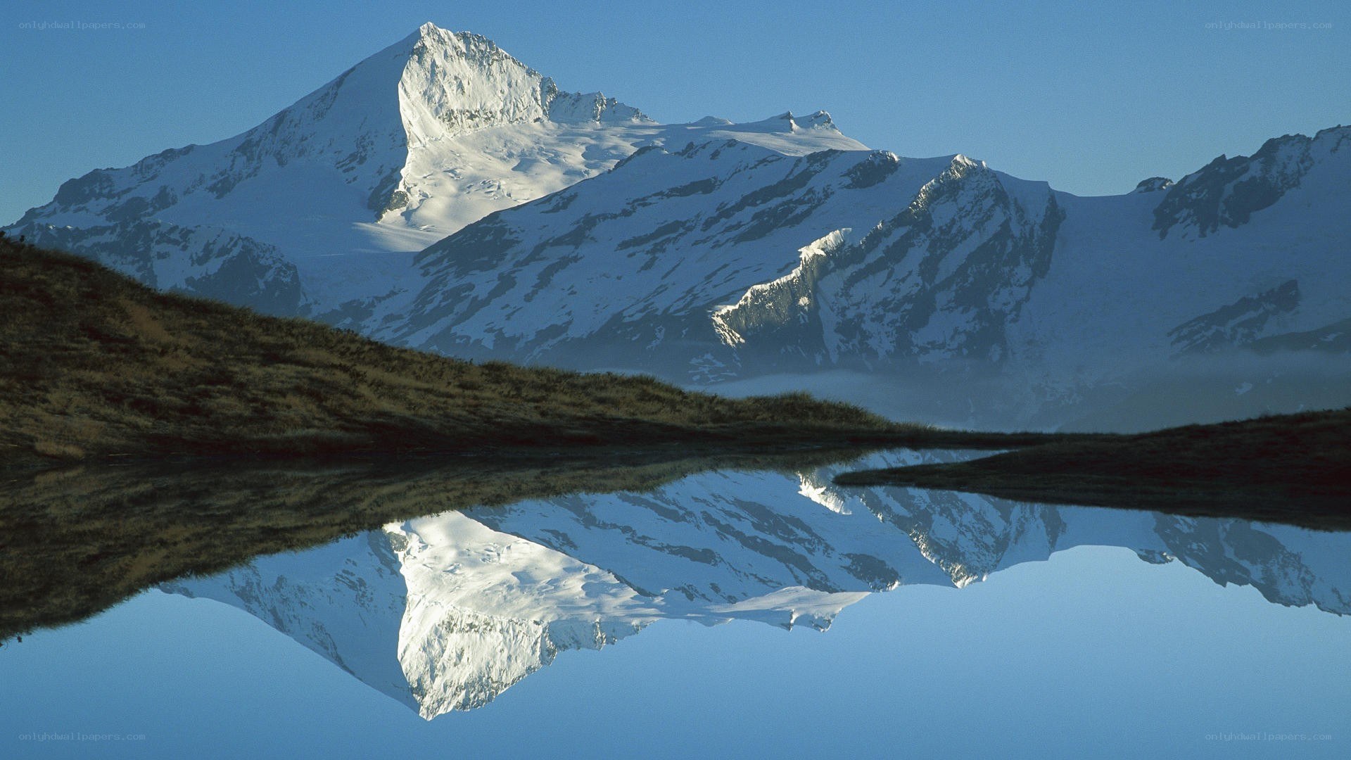 Snow-capped mountain reflected in lake