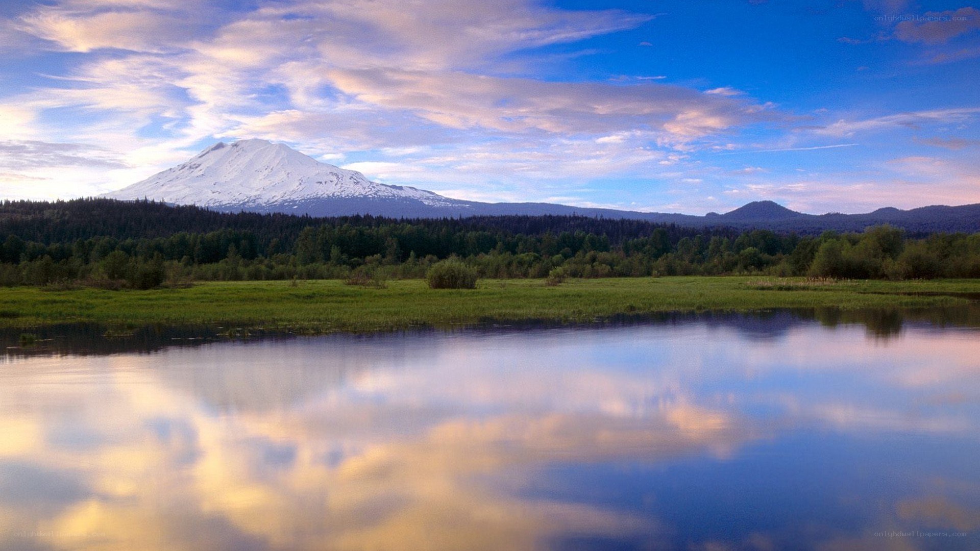 Snow-capped mountain reflected in lake