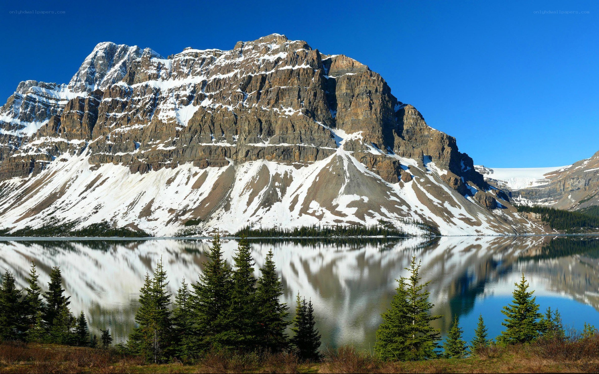Snow-capped mountain reflected in lake