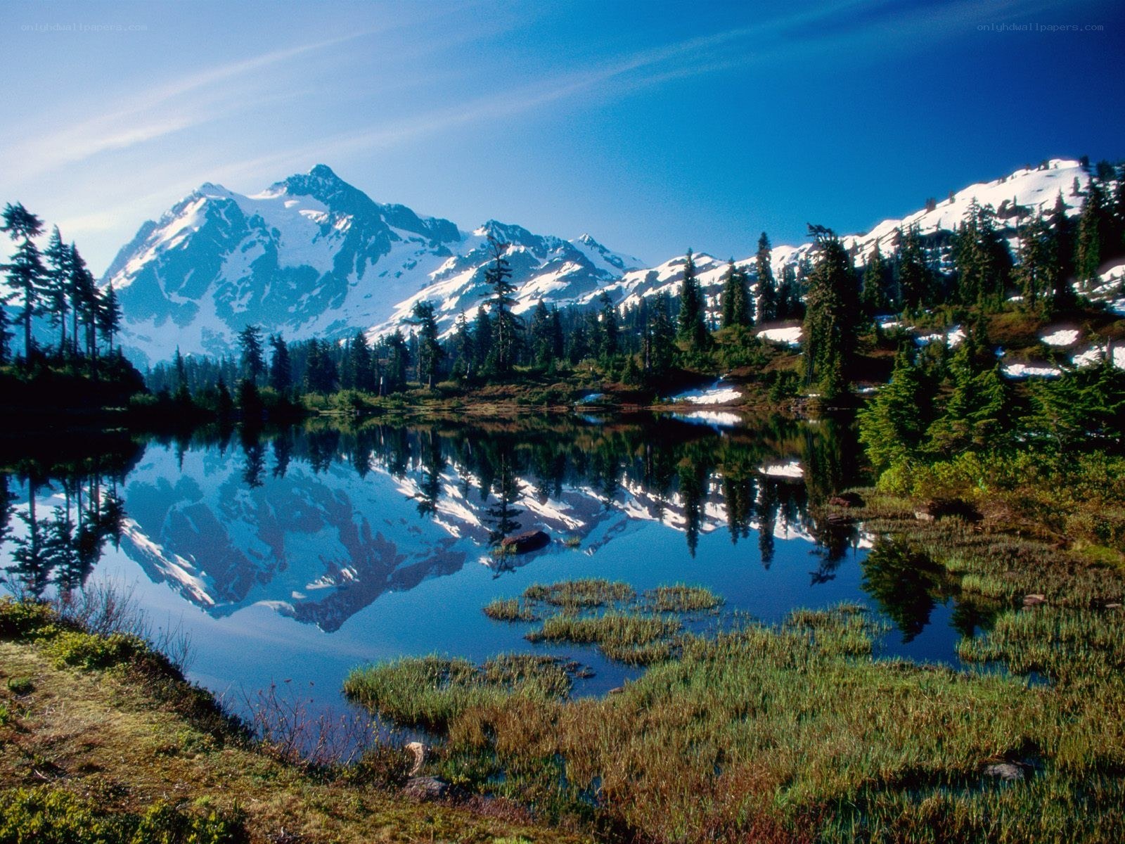 Snow-capped mountain reflected in lake