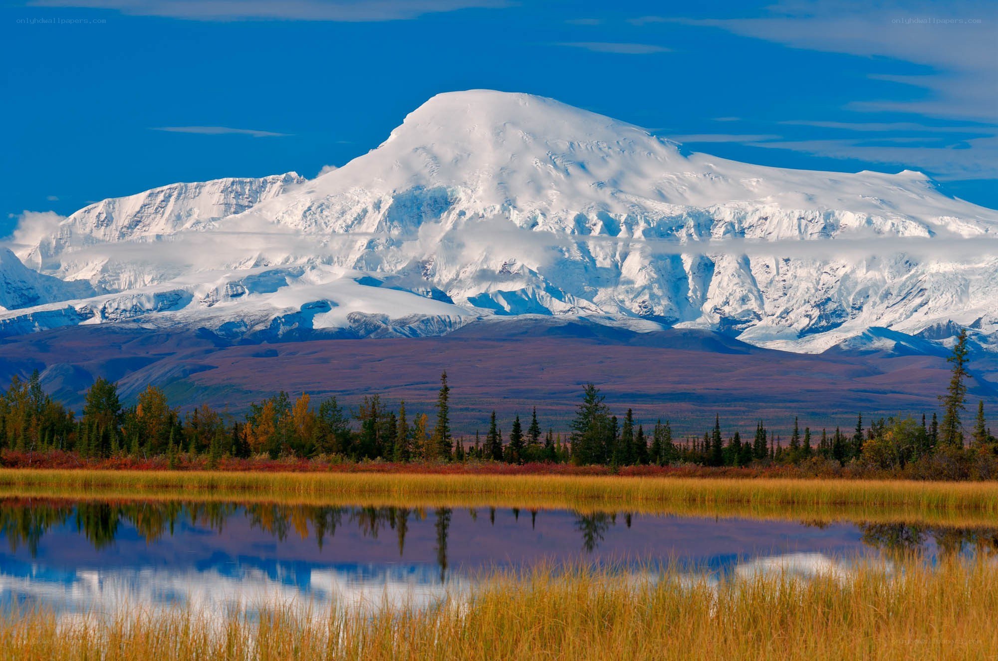 Snow-capped mountain reflected in lake