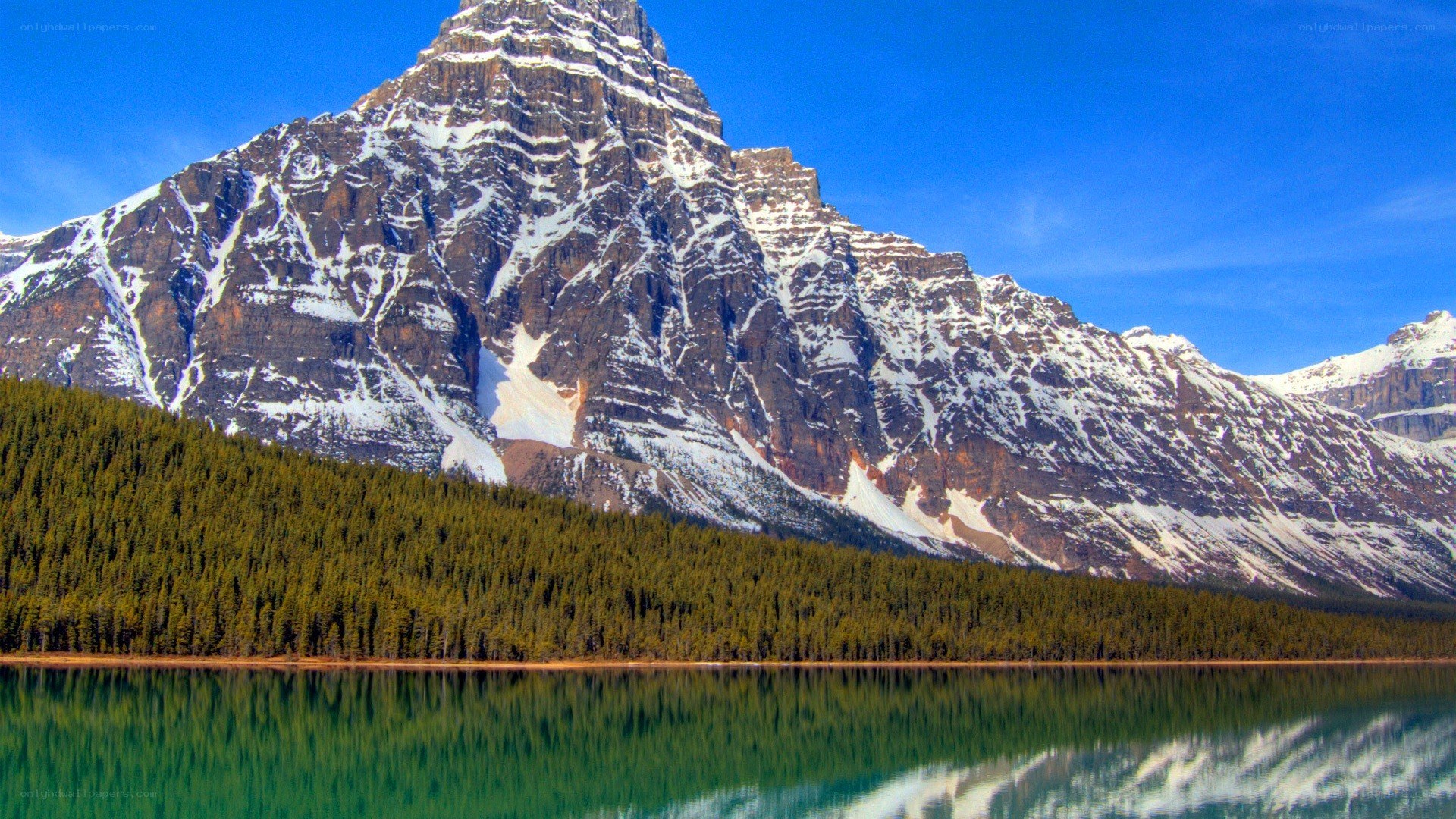 Snow-capped mountain reflected in lake