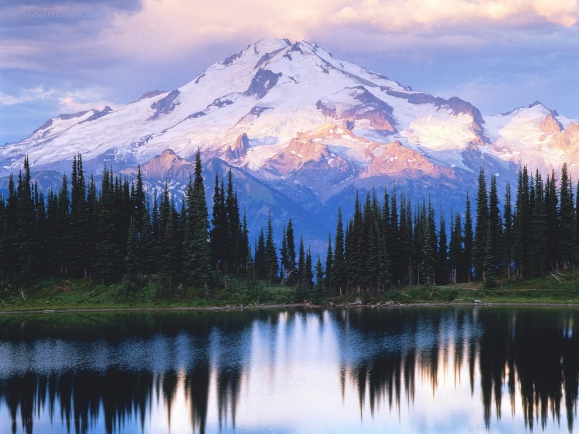Snow-capped mountain reflected in lake
