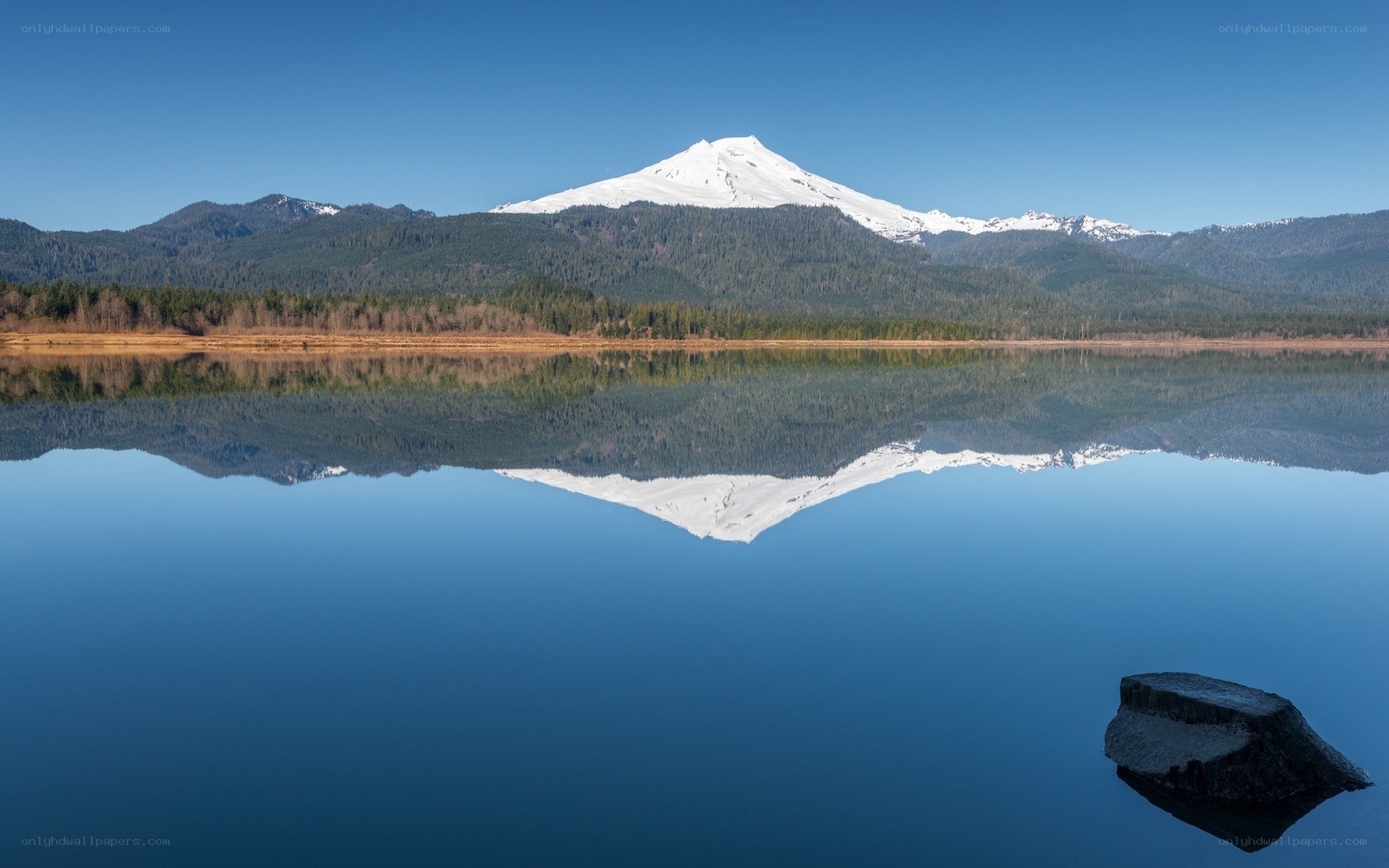 Snow-capped mountain reflected in lake
