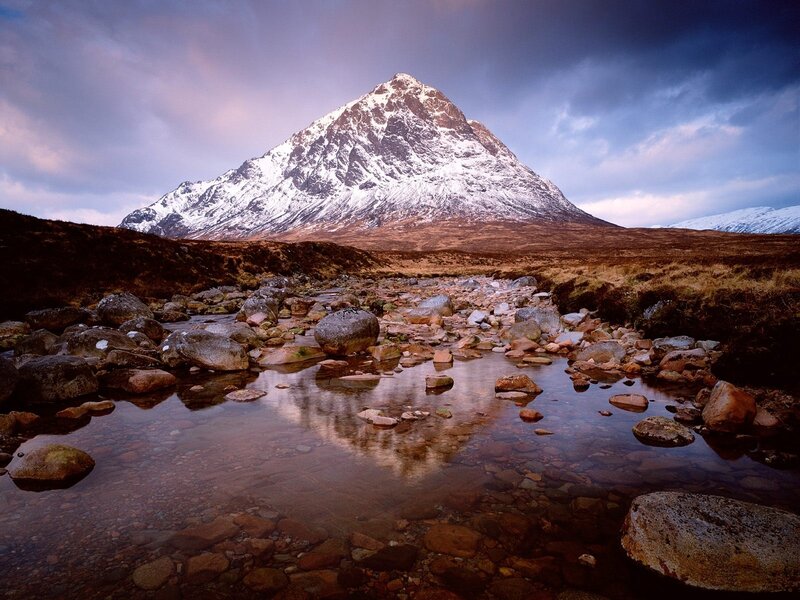 Snow-capped mountain reflected in stream