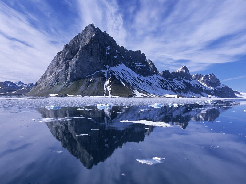 Snow-capped mountain reflected in water