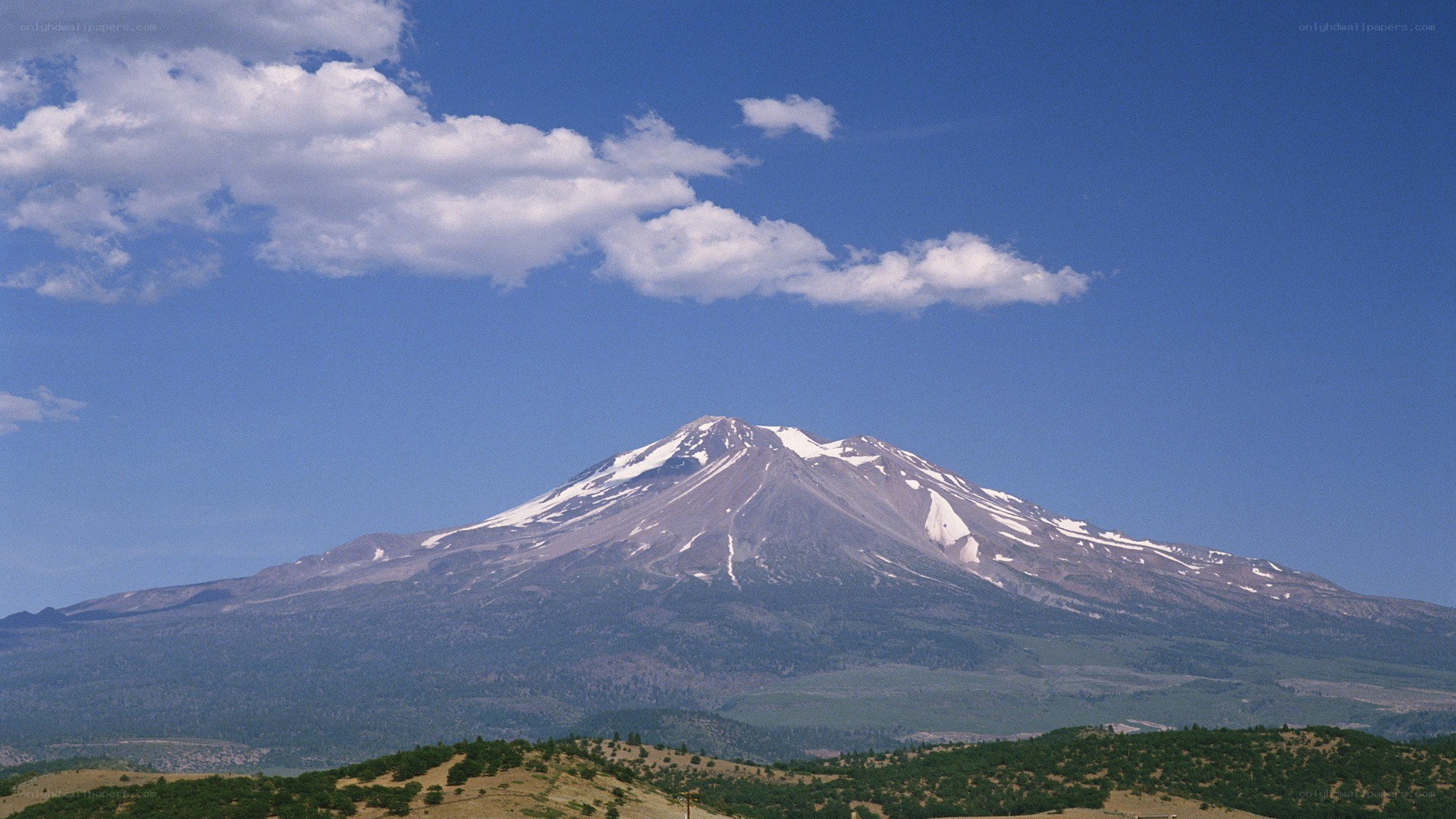 Snow-capped mountain under blue sky