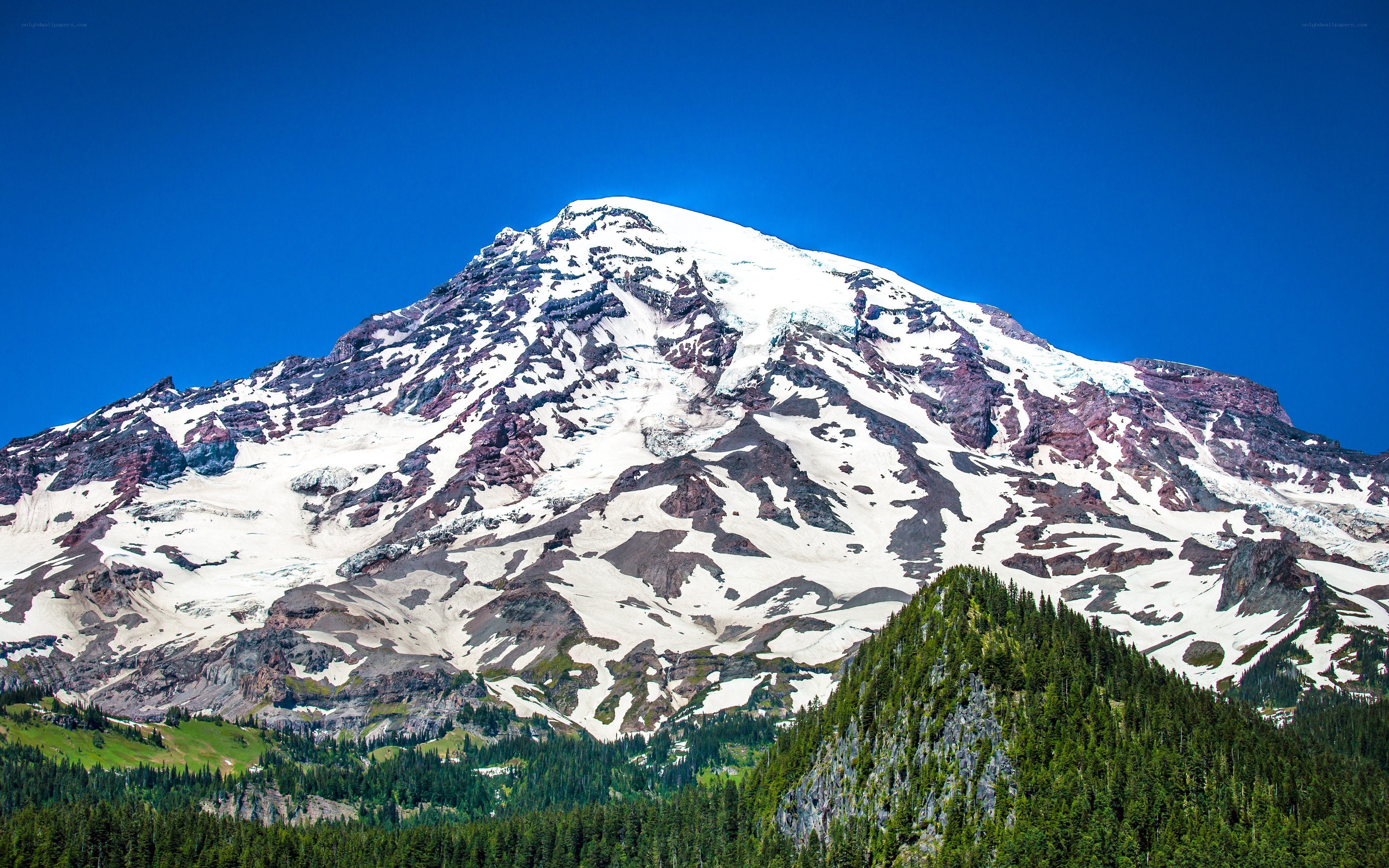 Snow-capped mountain under blue sky