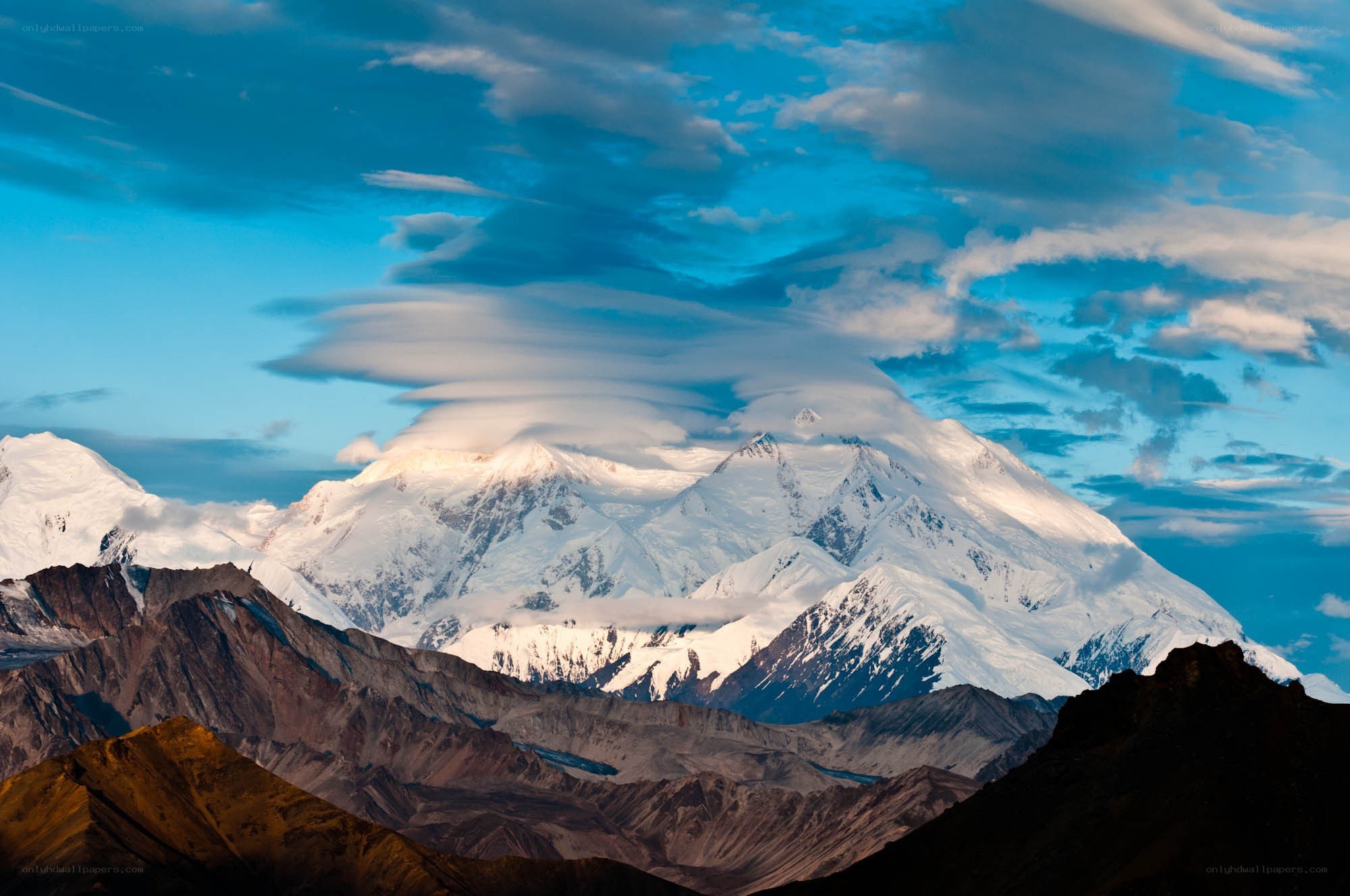 Snow-capped mountain under blue sky