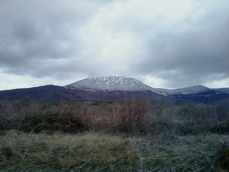 snow-capped mountain under cloudy sky