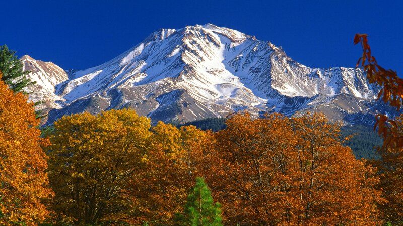 Snow-capped mountain with autumn trees