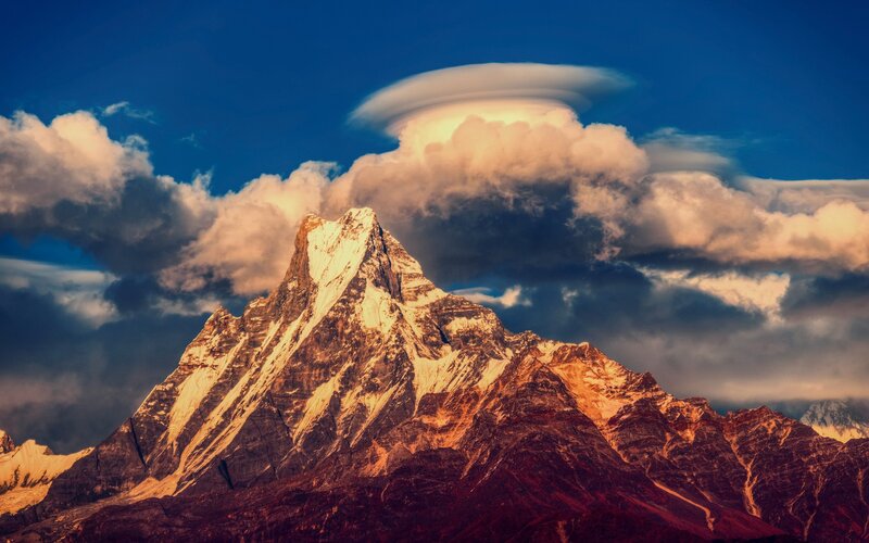 Snow-capped mountain with lenticular cloud