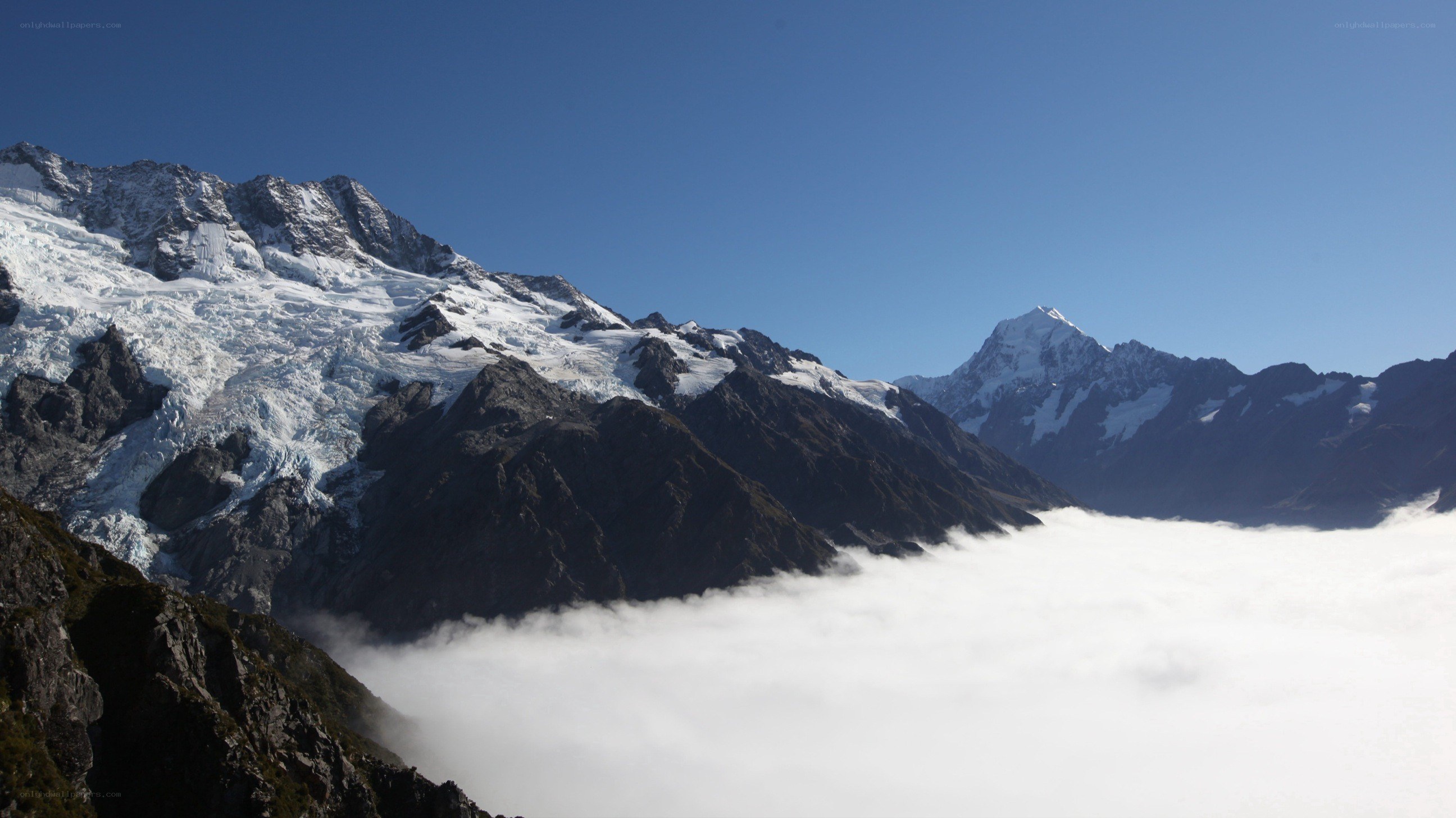 snow-capped mountains above clouds