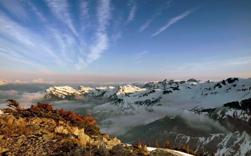 Snow-capped mountains above clouds