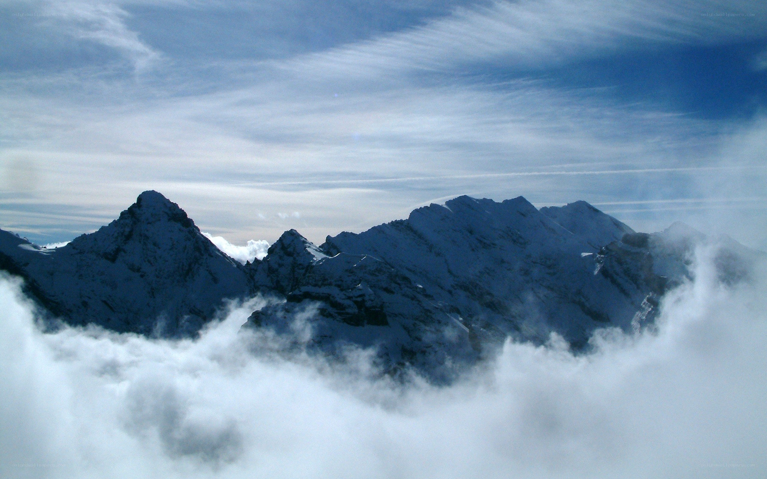 Snow-capped mountains above clouds