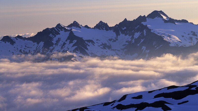 snow-capped mountains above clouds