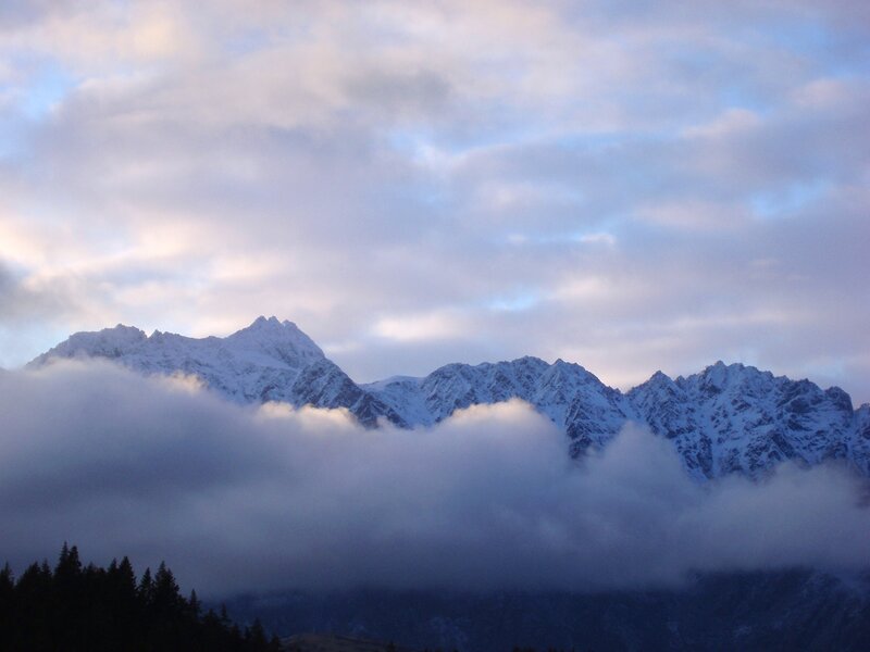 Snow-capped mountains above clouds