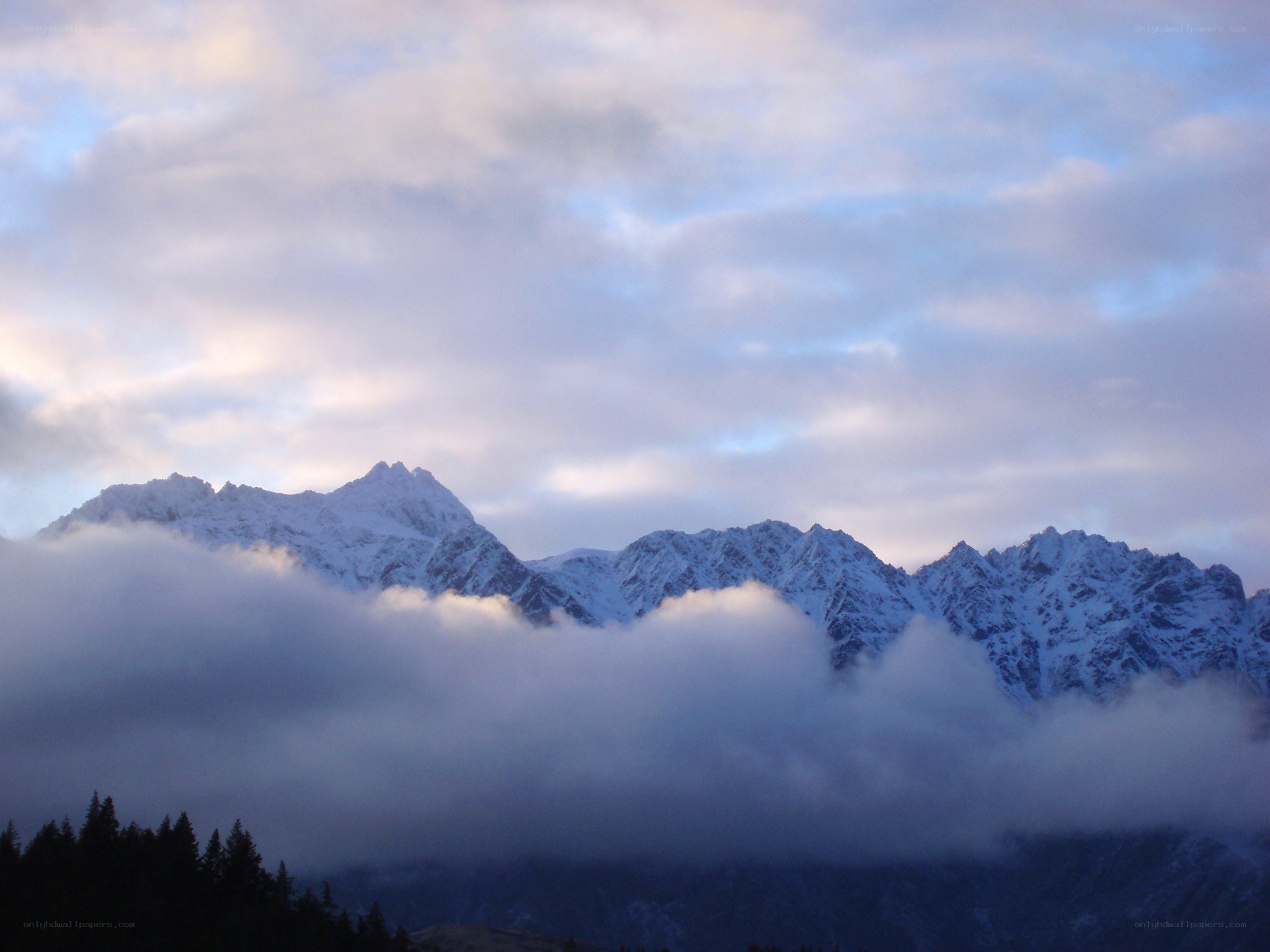 Snow-capped mountains above clouds