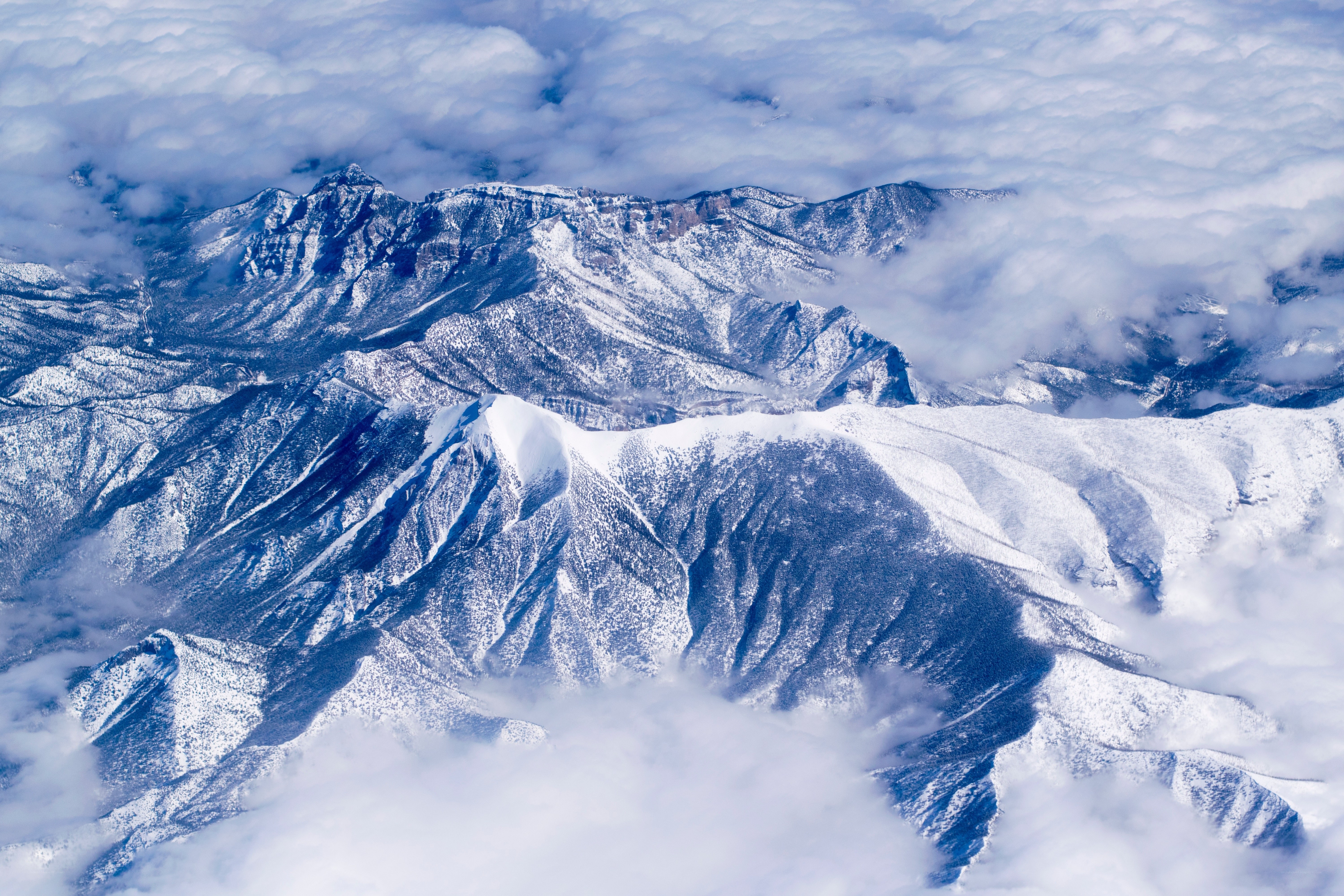 Snow-Capped Mountains Above Clouds