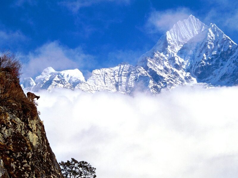 Snow-capped mountains above clouds