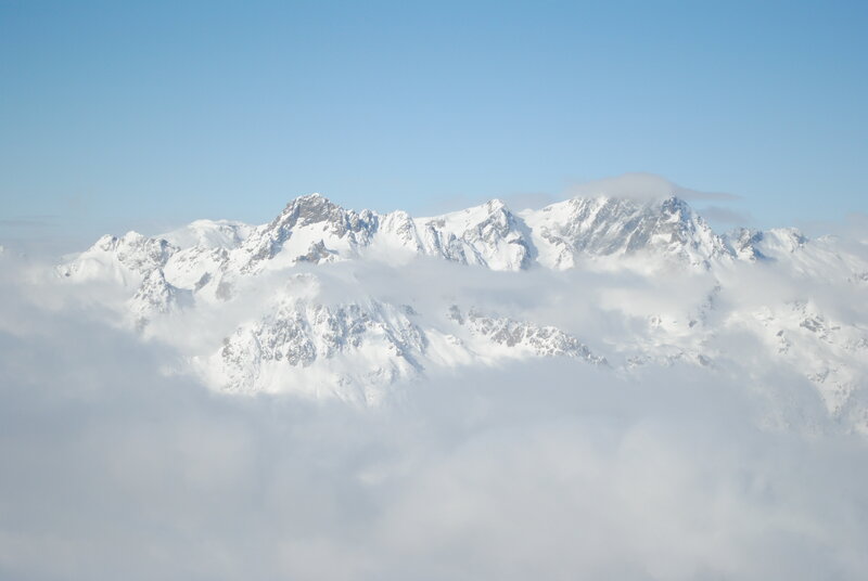 Snow-capped mountains above clouds