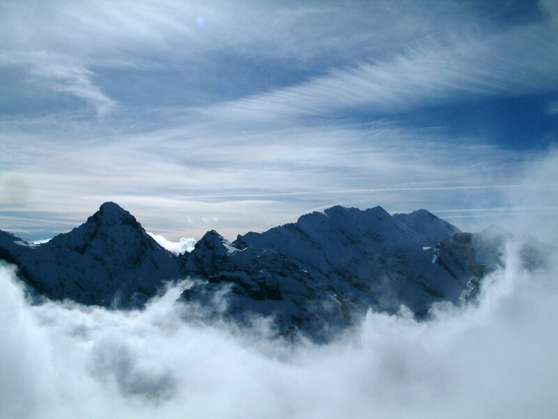 Snow-capped mountains above clouds
