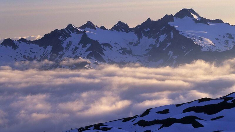 snow-capped mountains above clouds
